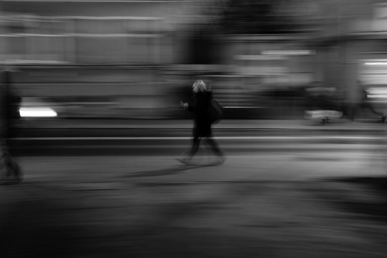A black and white photo of a person walking